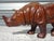A stunning decorative piece depicting an Asian rhinoceros. This handcrafted item is distinguished by its meticulous...