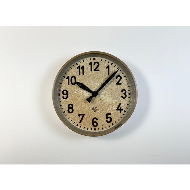 This wall clock was produced by Chronotechna in former Czechoslovakia during the 1950s. It features a brown metal frame,...