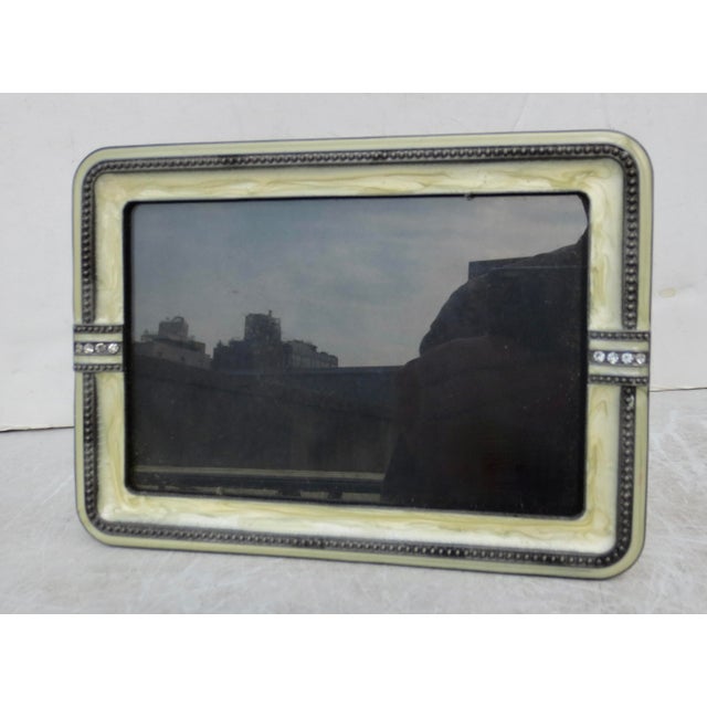 Celery green and rhinestone enamel frame on a heavy metal frame. Black velvet back with a glass face. Card corners are set...
