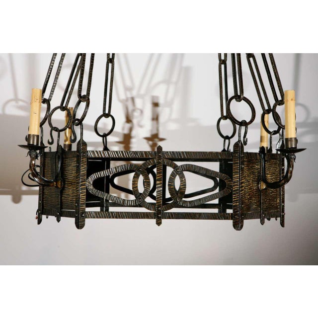 Finely hammered brass chandelier in the French style with four candelabra sockets.