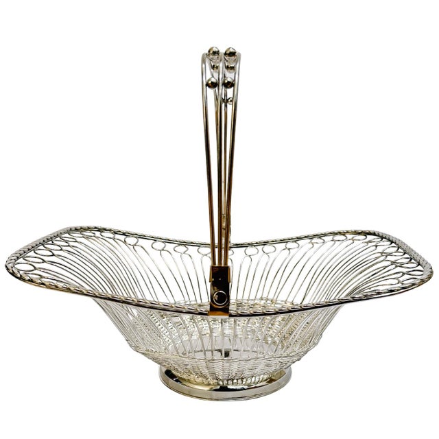 An elegant silver-plated basket features an intricate, airy wirework design that feels both classic and surprisingly...
