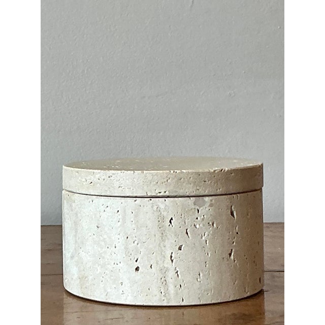 Embrace the raw, elemental beauty of natural stone with this exquisite vintage travertine lidded box. Masterfully carved...
