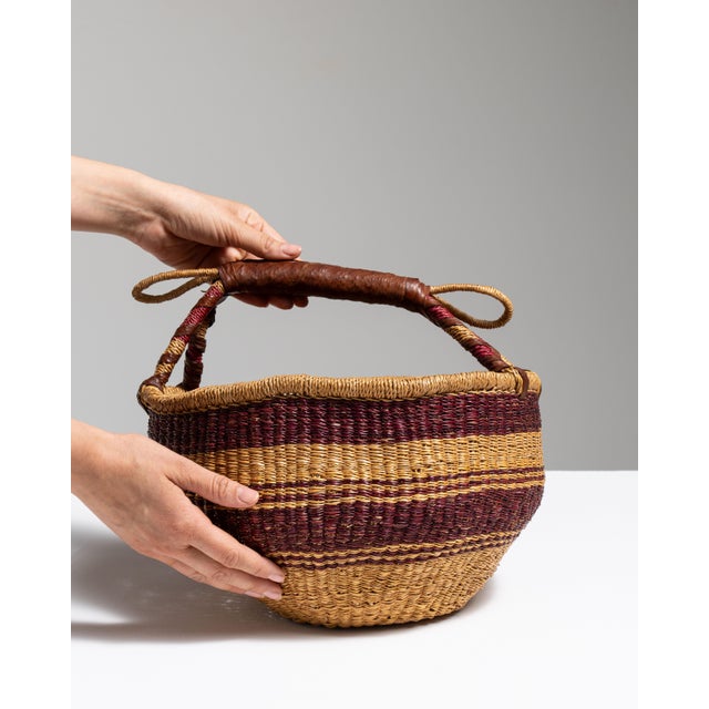 This mid 20th century basket from United Kingdom is finished in tan, worked in wicker. Its form follows honest, well-...