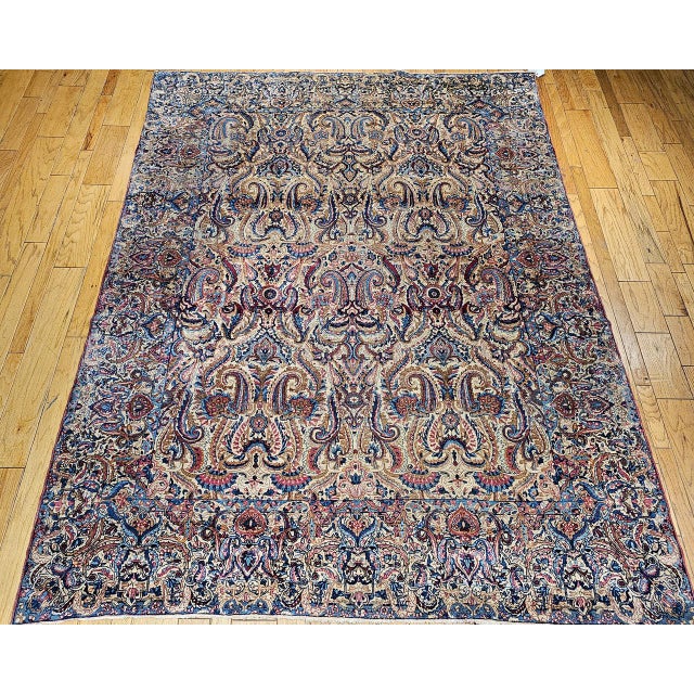 "This rare near-square vintage Persian Kerman Lavar rug, woven in the first quarter of the 1900s, showcases a remarkable...