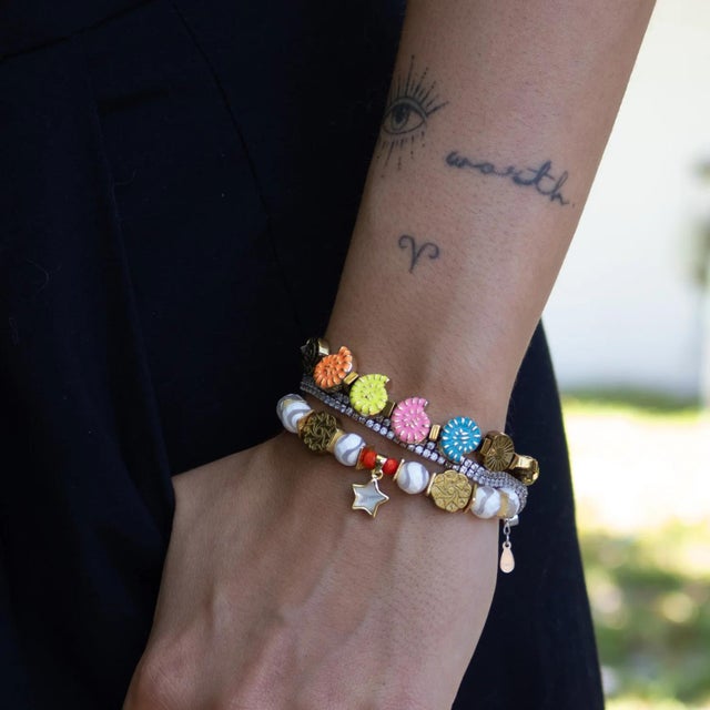 Embrace color, energy, and beachside charm with the Joyful Sea Shell Colorful Beaded Bracelet. Designed with bright enamel...