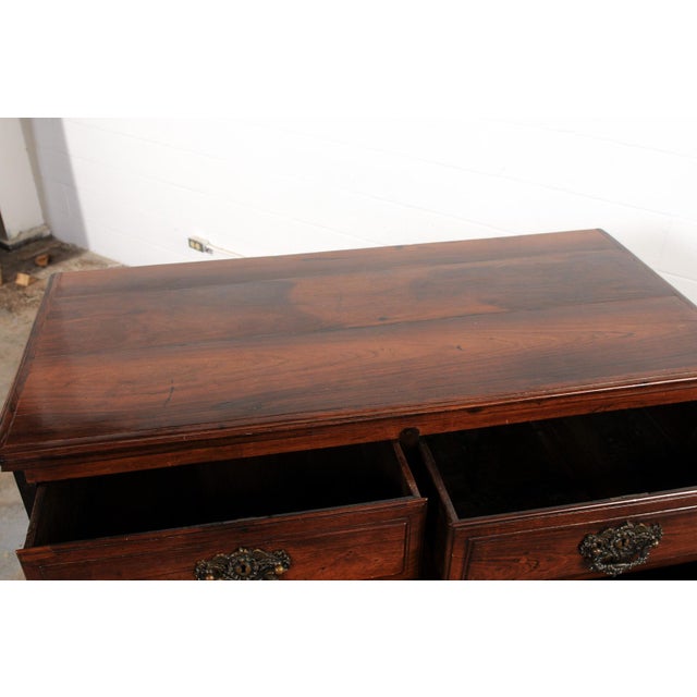 A handsome Portuguese chest of five drawers, crafted from richly figured rosewood, from the early 19th century. This...