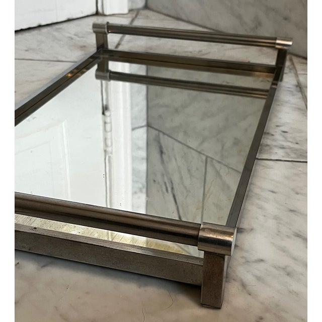 This slim line and sophisticated chromed metal tray works in a variety of settings. This piece is attributed to...