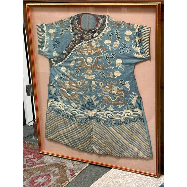 Design Plus Gallery presents a Framed Silk Kimono in the Qing Dynasty Style. The blue Chinese robe is embroidered in silk...