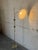 This adjustable brass floor lamp features a slender stem and a classic pleated shade casting warm ambient light. Designed...
