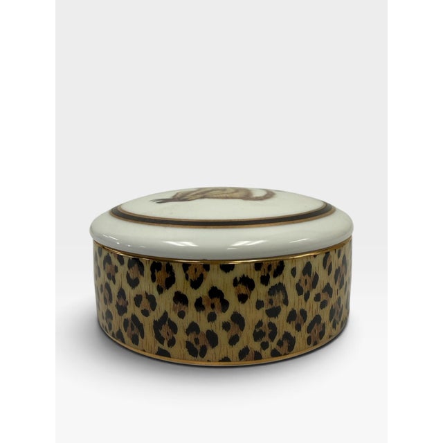 Add a wild, sophisticated touch to your vanity or tabletop display with this beautiful vintage porcelain lidded trinket...