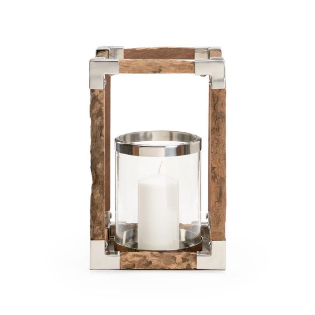 Candles provide ambiance throughout any space. This rustic modern hurricane features the juxtaposition of polished nickel...