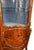 An elegant 19th-century French Louis XV-style vitrine, finely crafted with richly figured wood veneers, floral marquetry,...