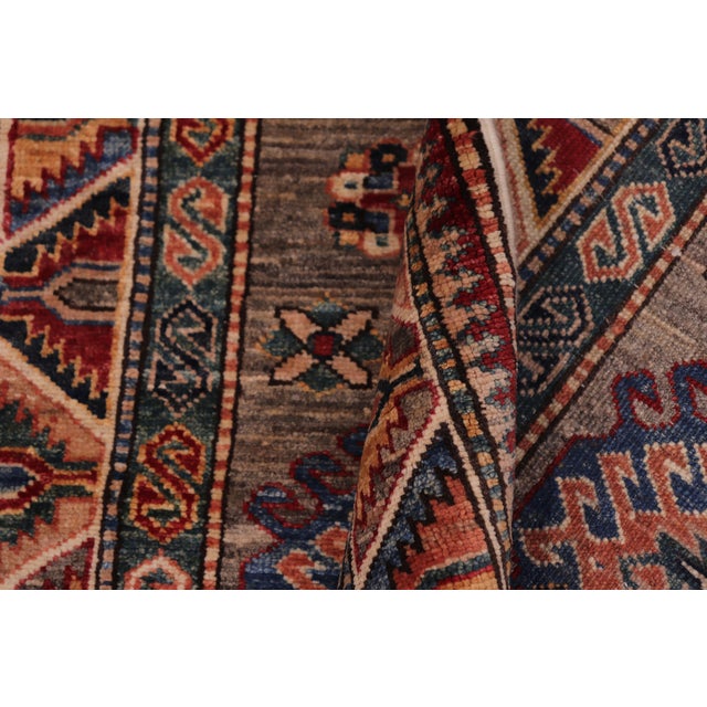 "Transform your home with this stunning hand-knotted Super Kazak rug, expertly crafted from premium hand-spun wool and...