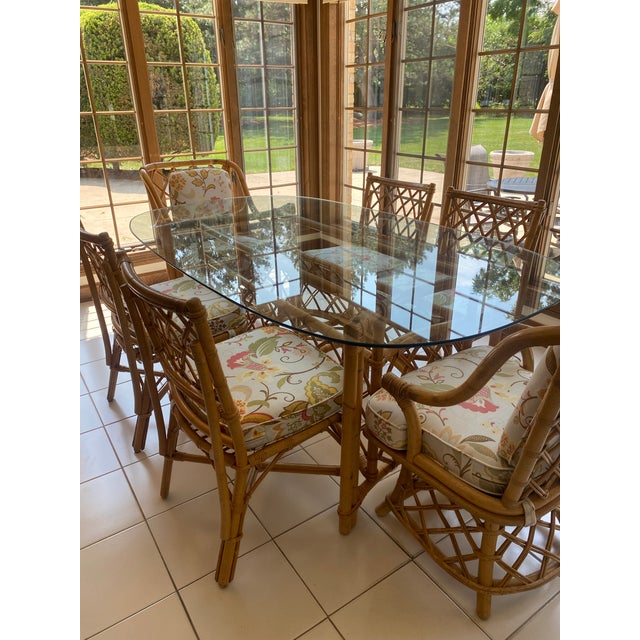 Authentic Ficks Reed Vintage rattan dining set with glass-top table and 6 matching chairs. Classic coastal style that...