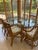 Authentic Ficks Reed Vintage rattan dining set with glass-top table and 6 matching chairs. Classic coastal style that...