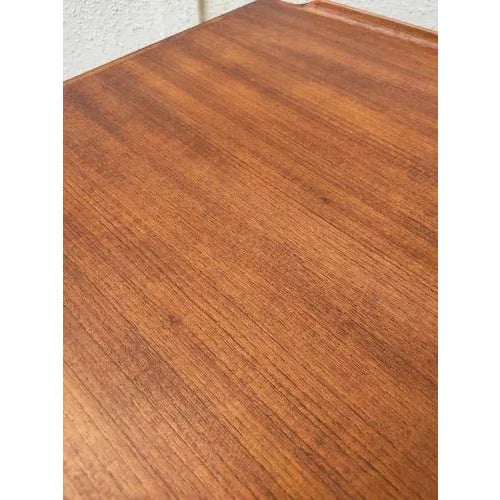 Elegant teak desk made in Denmark in the 1970s, with a classic and functional design, six drawers, and a front shelf....