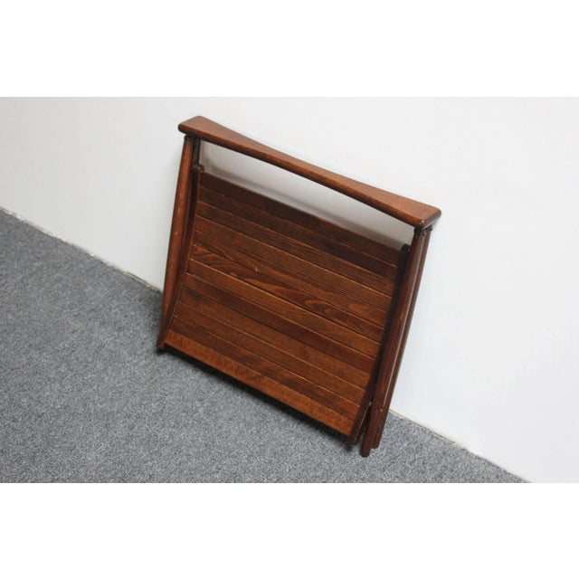 Yugoslavian magazine rack in stained beechwood manufactured by Nasco (ca. late 1960s, early 1970s). Sculptural form with...
