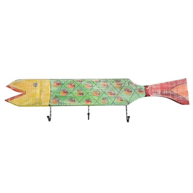 Hand-painted folk art fish wall towel rack featuring a colorful, whimsical design with geometric and scale-like decoration...