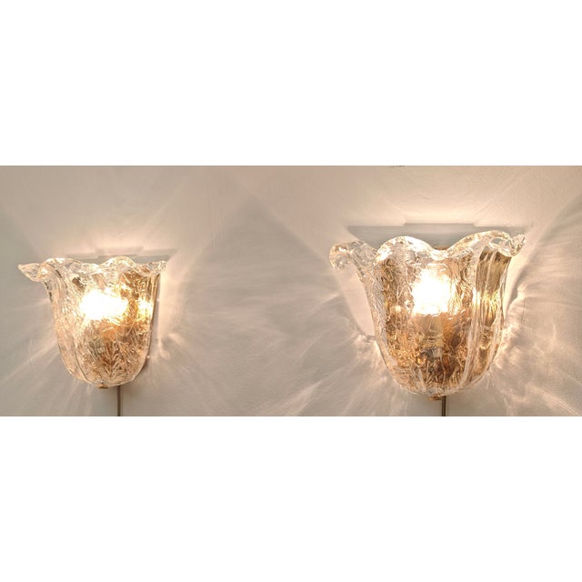 These vintage wall lamps are made of thick, mouth-blown Murano glass, often dating back to the 1970s and 1980s. The design...
