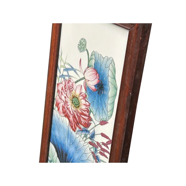 This elegant Chinese porcelain plaque, set within a slender dark wood frame, depicts a classic "egret and lotus" motif, a...