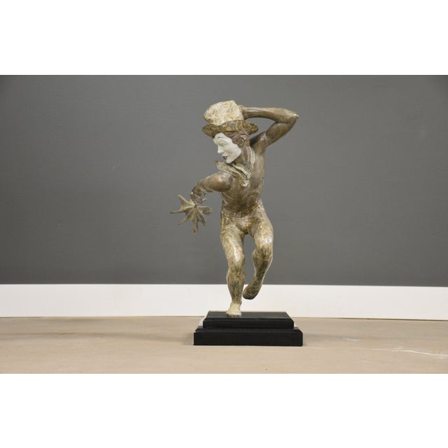 A bronze sculpture titled “Into the Wind” by Donald Huntsman after a mime Marcel Marceau. Circa 1990’s. Made in USA....