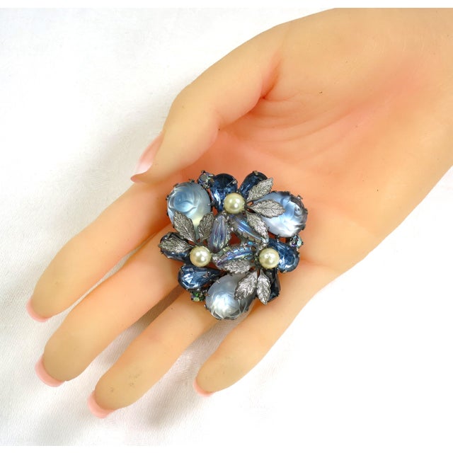 1950s silver-plated art glass & crystal brooch. Pale blue moonstone art glass stones carved as roses are surrounded by...