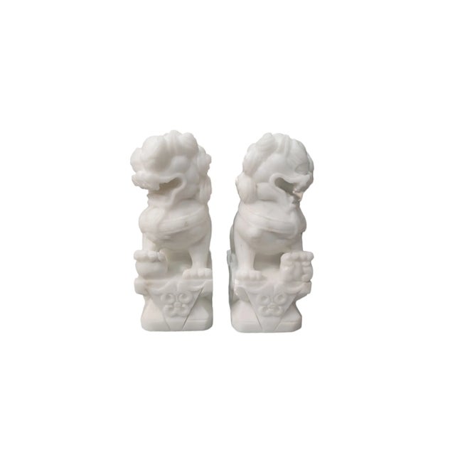 Vintage pair of white marble foo dogs. Foo dogs are in the dueling stance.