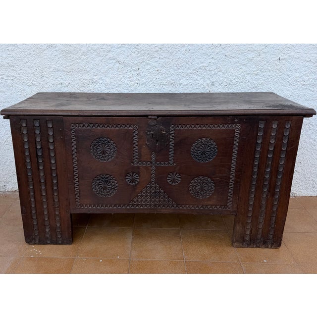 Beautiful antique Spanish wooden chest dating from the 19th century, featuring intricate hand-carved geometric decorations...