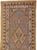 This early 20th-century Persian Serab runner presents a finely organized tribal composition across a warm camel and soft...