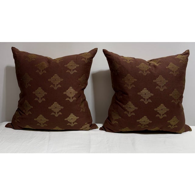 Pair of Schumacher Rubia pillows backed in solid brown. Down filled with zipper detail on the solid side