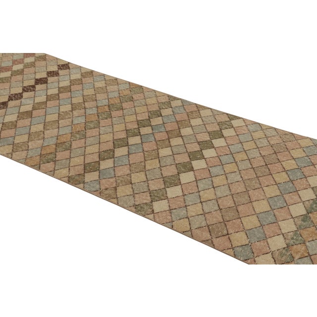 This vintage rug is a 3x10 Turkish distressed piece, made with hand-knotted wool circa mid-20th century. It is an exciting...