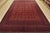 A traditional Turkmen rug hand-knotted with fine wool and natural dyes. This rug features rows of geometric medallions...
