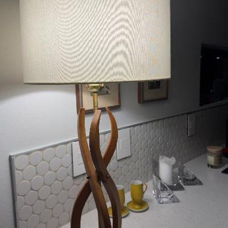 A striking American Mid-Century Modern table lamp dating to the 1960s, constructed from sculpted solid hardwood elements...
