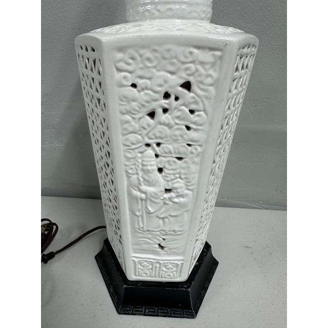 A refined vintage Blanc de Chine porcelain table lamp featuring a sculptural hexagonal form with pierced and relief-...