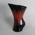 A true 1950s vase crafted in a combination of brown, red, and black glaze with a glossy finish. "Céramique Fady"...