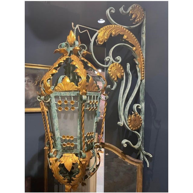 Monumental wrought iron outdoor Lantern suspended by a coat hook. These majestic lanterns are most decorative. Six are...
