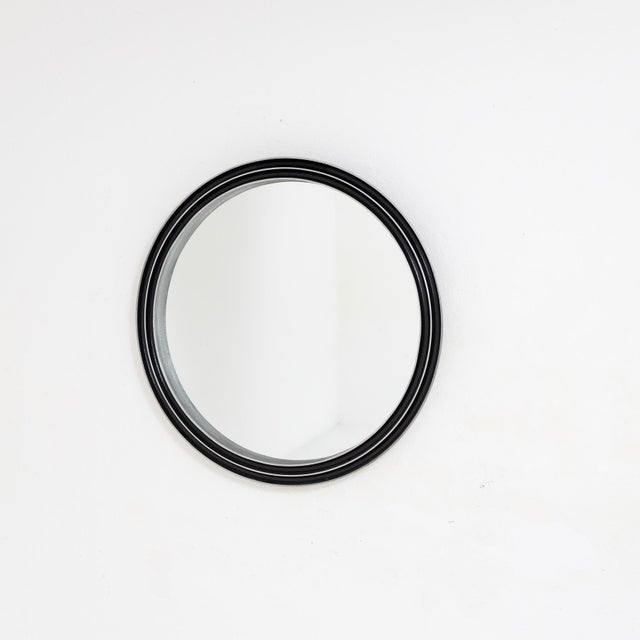 A sculptural mirror created by Lorenzo Burchiellaro in the 1970s. The piece features an aluminum structure with a textured...
