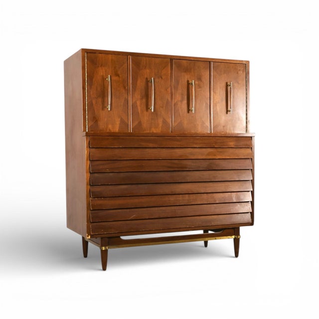This 1960s vintage mid century modern highboy dresser by American of Martinsville from the Dania Collection features a...