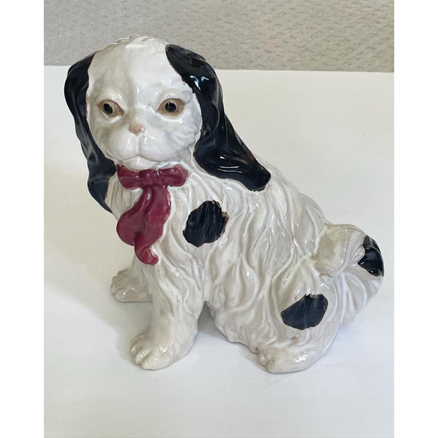 A charming large Staffordshire style black and white spaniel with a sweet ribbon around its neck. So decorative!