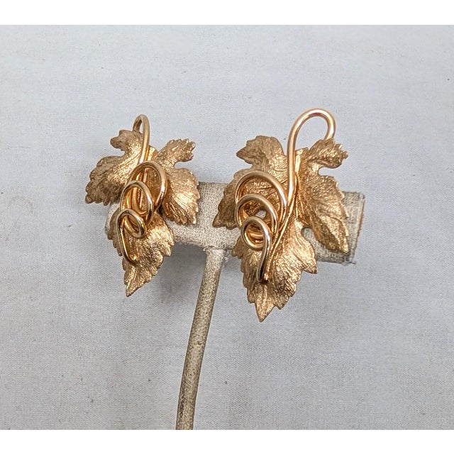 1950s textured goldtone leaf with curled stem butterfly clip earrings. Marked "NAPIER PAT. PEND." on the clips. Measure: 1...