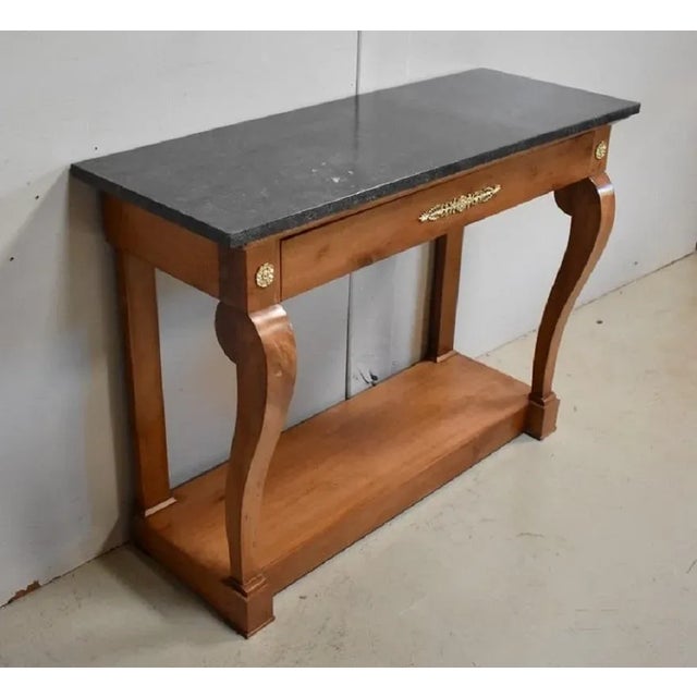 Console in solid Cherry wood, with top in Granite Marble with Black dominance. It opens in the belt by a drawer offering a...