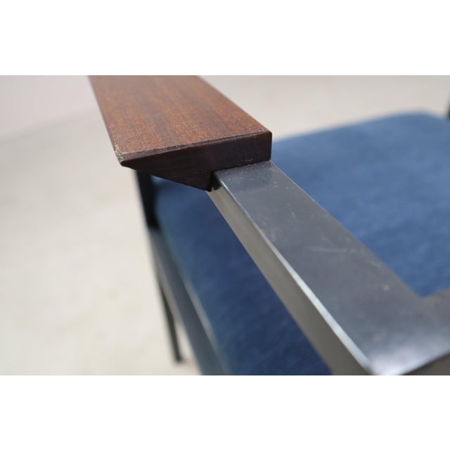 This pair of vintage armchairs showcases the bold geometry and material contrasts characteristic of postmodern design....