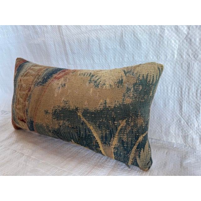 This 17th century Flemish tapestry pillow is crafted from an original handwoven wool fragment, showcasing an abstracted...