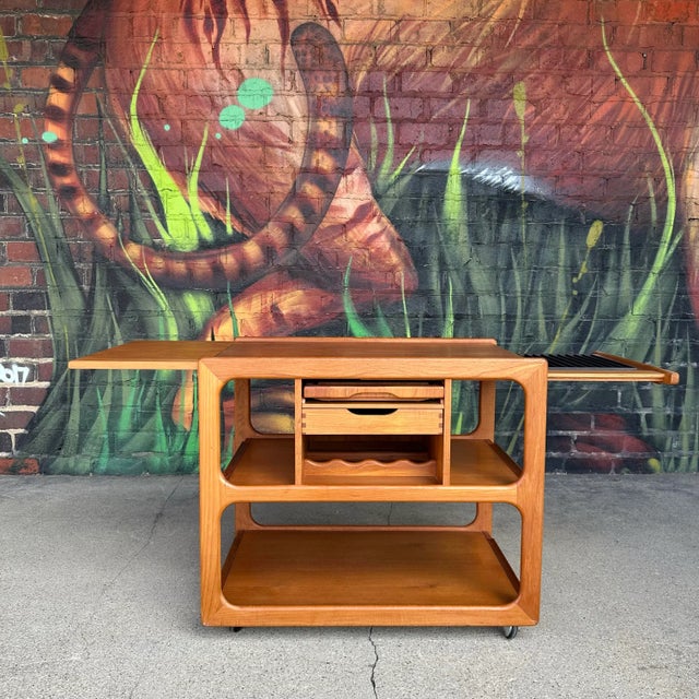 This is an amazing Danish rolling bar cart from the 1960s made from teak and designed by Salin Nyborg. The sculptural...