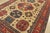 A tribal Kazak rug hand-knotted with fine wool on a cotton foundation. This oriental rug features a large central...