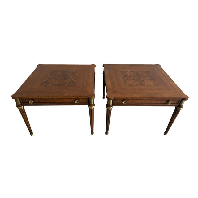 A refined pair of Baker side tables, featuring beautifully figured veneer tops with unique grain - no two exactly alike....