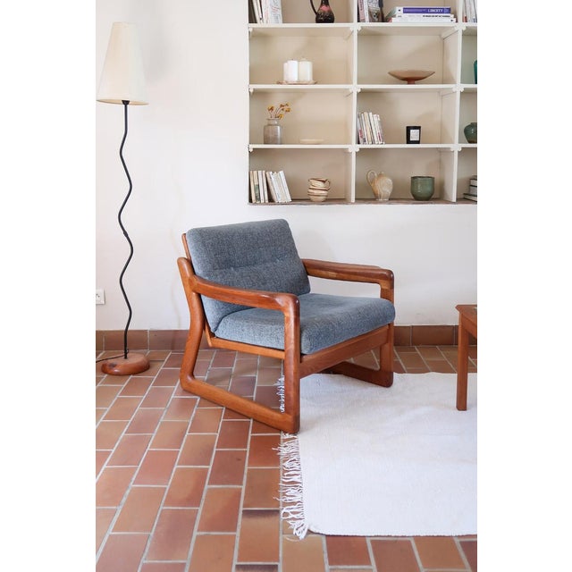 A matching pair of teak lounge chairs produced by Komfort and made in Denmark in the 1960s. The plate is still in place...