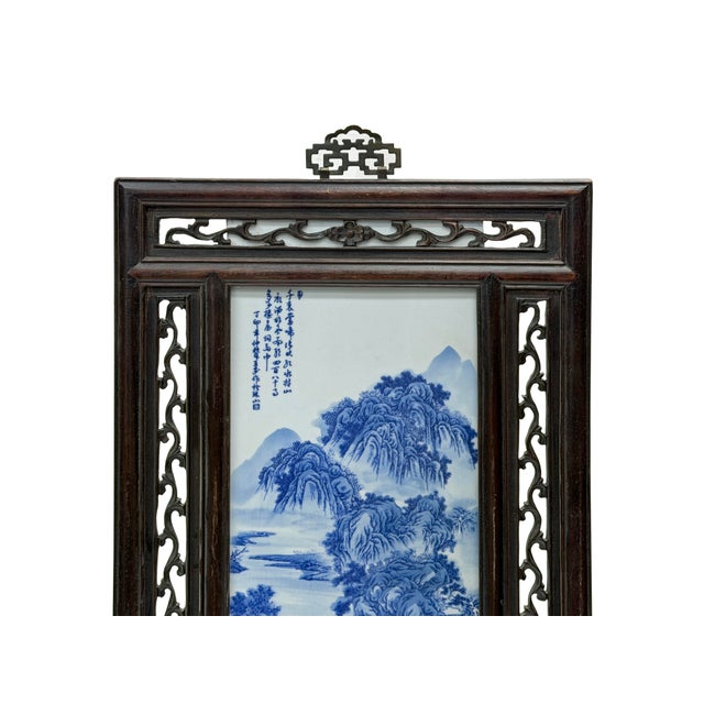 This exquisite vintage Chinese framed porcelain plaque features a vertical blue-and-white landscape scene housed within a...