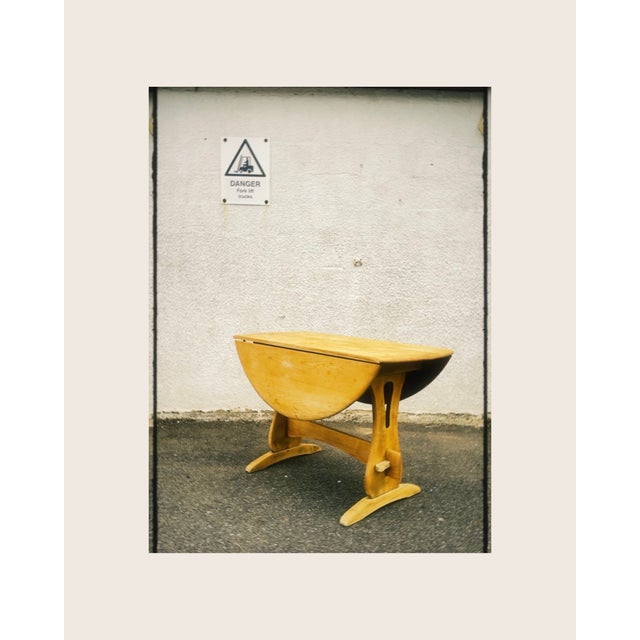 Early model Ercol drop leaf circular dining table. Arts and crafts in style with the fabulous designed legs and stretcher....