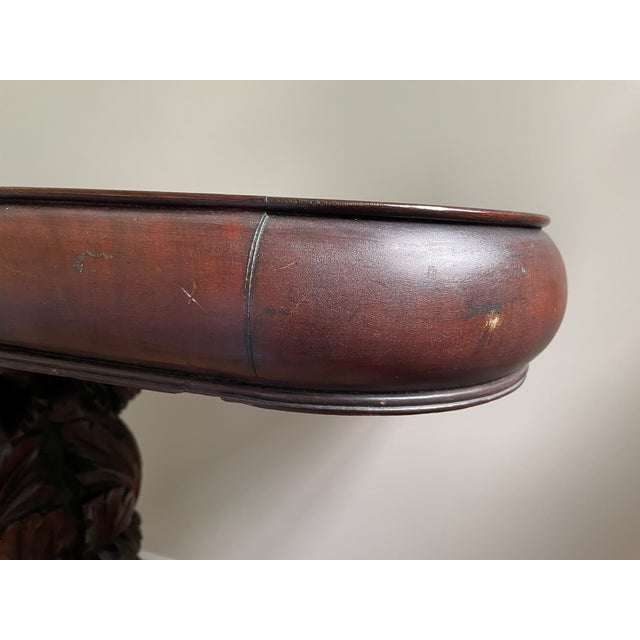 A richly carved late 19th‑century Continental Rococo Revival gueridon table in solid mahogany, featuring a rotating...